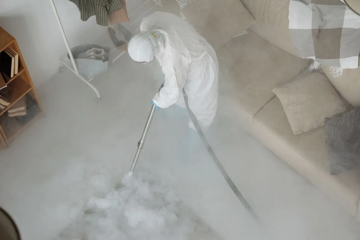 Biohazard cleanup technician in protective equipment, Duquesne, PA